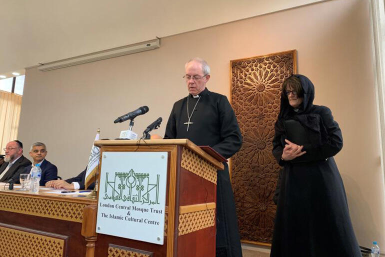 Archbishop of Canterbury Justin Welby speaks at Regent's Park Mosque, flanked by Archdeacon of Canterbury Jo Kelly-Moore.