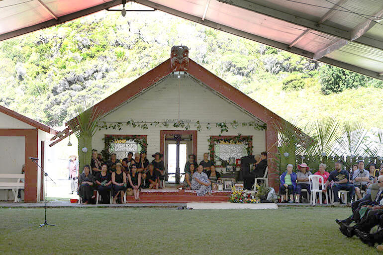 Kauaetangohia marae, as seen through the marquee over the marae atea. Kauaetangohia marae, as seen through the marquee over the marae atea.
