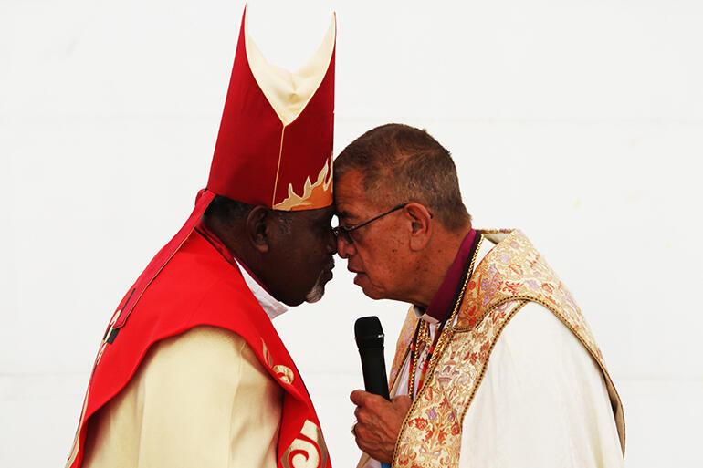 Heartfelt: Bishop Saibo Mabo, who is from the Torres Strait Islands, exchanges the hongi with Bishop John Gray.