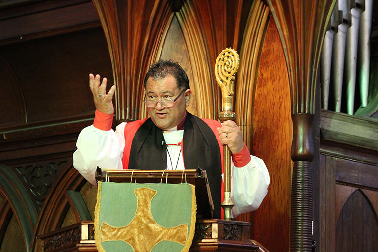 Bishop Kito Pikaahu preaches his kauwhau, with Te Take ki Oihi in hand.