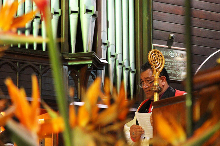 Tongues of fire? Bishop Pikaahu, as seen through the lectern floral arrangement. Tongues of fire? Bishop Pikaahu, as seen through the lectern floral arrangement.