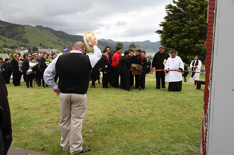 An unexpected pause as the funeral party passes Huiwhenua, the wharenui at Tuatini Marae.