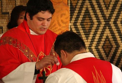 The Rev Michael Tamihere gives communion to his brother Don.
