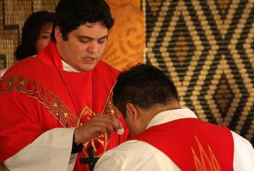 The Rev Michael Tamihere gives communion to his brother Don.