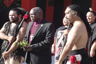 The Archbishop of York is flanked by warriors during his welcome to Te Hepara Pai.
