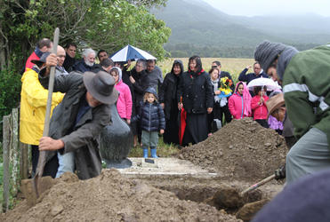 The wind squalls and the rain falls as Hone is laid to rest.