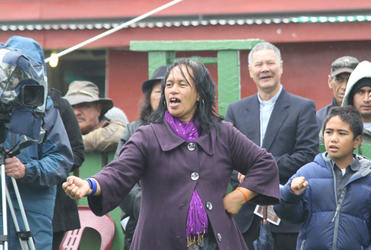 Undeterred by the rain, folk swing into another action song.
