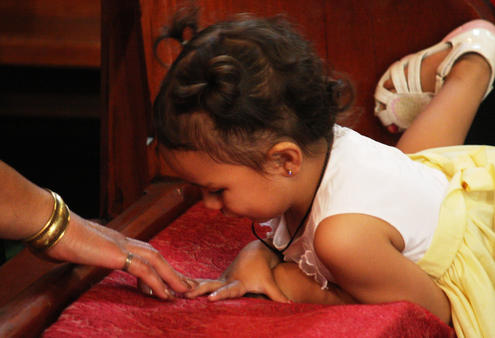 One of the younger crew at the powhiri makes her connection with an older friend.