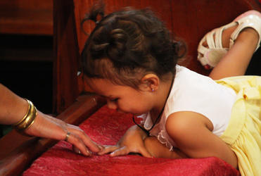 One of the younger crew at the powhiri makes her connection with an older friend.