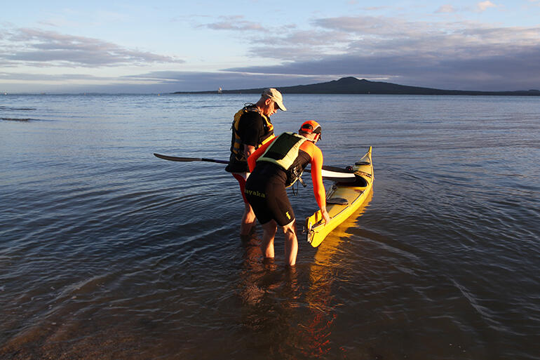 The gentle ripples seem to echo the iconic skyline silhouette of Rangitoto.