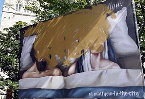The St Matthew's billboard after a protestor took a paint brush to it.