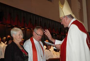 Archbishop Phillip Aspinall blesses Bishop Tom and Dwyllis Brown.