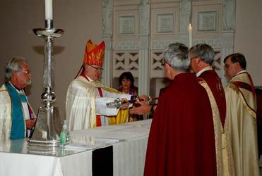 Bishop Tom lays up his crozier on the altar at Wellington Cathedral of St Paul.