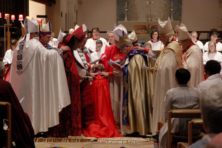 Eleanor Sanderson's new peers ordain her bishop in the laying on of hands.
