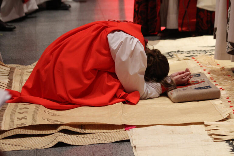 Veni Sancte Spiritus! Eleanor prays as she kneels on fine mats from Tonga and the people sing. 