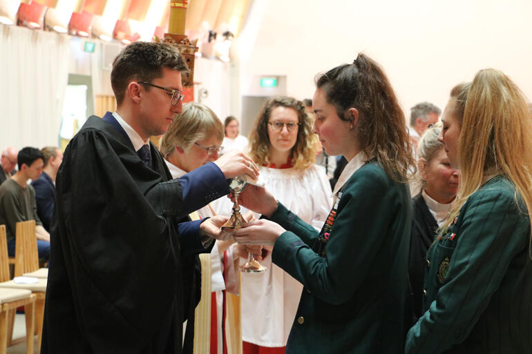 St Margaret's College students Hannah Langley and Virginia Macdonald receive the Eucharist from diocesan Vice Chancellor, Alex Summerlee. St Margaret's College students Hannah Langley and Virginia Macdonald receive the Eucharist from diocesan Vice Chancellor, Alex Summerlee.