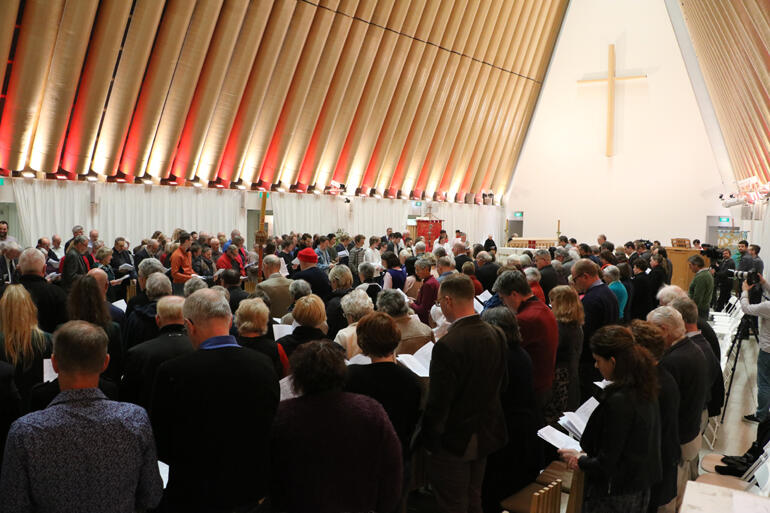 Synod members stand to sing during this year's Synod Eucharist at the Christchurch Transitional Cathedral. Synod members stand to sing during this year's Synod Eucharist at the Christchurch Transitional Cathedral.