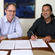 Anglican Church General Secretary Michael Hughes with Justin as he signs the paperwork that formally confirms him as Bishop.