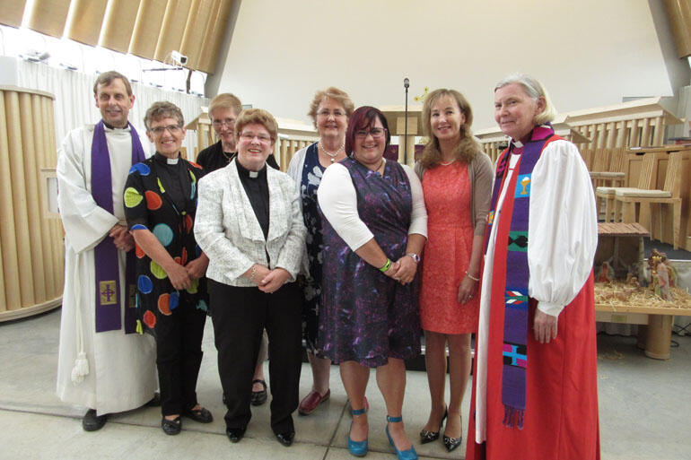 Archdeacon Peter Carrell and Bishop Victoria Matthews pose with the CAIRA graduates (see story).