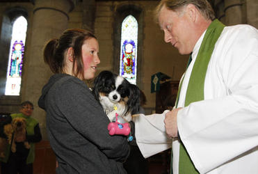 Nelson's Dean Nick Kirk blesses Fiona Saunders and Yuki. Photo: Patrick Hamilton.