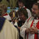 Bishop Mark MacDonald (from Alaska) receives communion from Bishop Victoria.