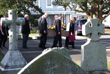 The pallbearers - with Jenny's son James at the rear - bear Jenny through the old St Peter's church graveyard to the hearse.