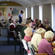 Bishop Matthews says grace for the Churchill Courts residents, as they prepare to eat their evening meal in a corridor.