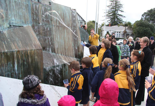 Kids from Parnell School and the Kathedral Kids splash water from the nearby Waipapa Stream, a place for early local baptisms.