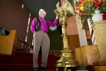 Bishop John Bluck strokes Napier's eagle in anticipation of a happy landing. Photo: Glenn Taylor