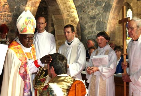 March 2010: Jamie Allen, centre, watches as Archbishop John Sentamu installs Philip Richardson as the first Bishop of Taranaki.