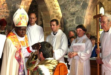 March 2010: Jamie Allen, centre, watches as Archbishop John Sentamu installs Philip Richardson as the first Bishop of Taranaki.