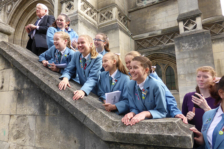 Students from St Hilda's Collegiate watch the royal walkabout from the steps of St Paul's Cathedral.