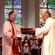 Preacher Jim White hands the new bishop two essential tools of office: a basin and towel.