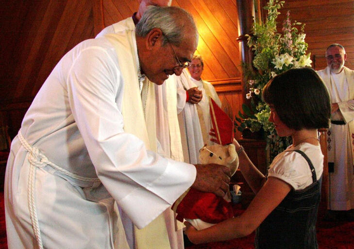 Hannah Crosse from Weber presents Waiapu's Bishop Bear to Archbishop Brown Turei.