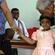 Sharon is a bashful birthday girl - and she's being encouraged here by Fr Ben Tapelu.