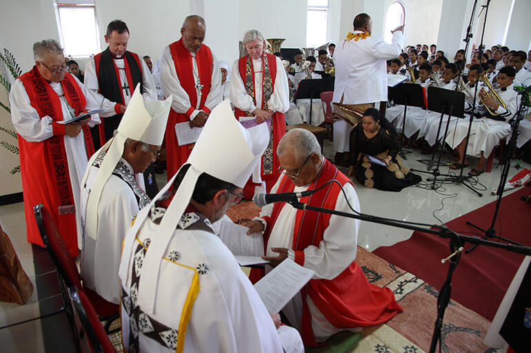 Bishop-elect 'Afa kneeling as he awaits the invocation of the Holy Spirit.