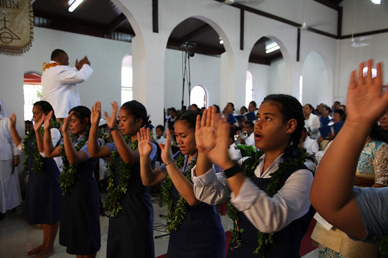 Girls from St Andrew's High School performing action song during the Gloria.