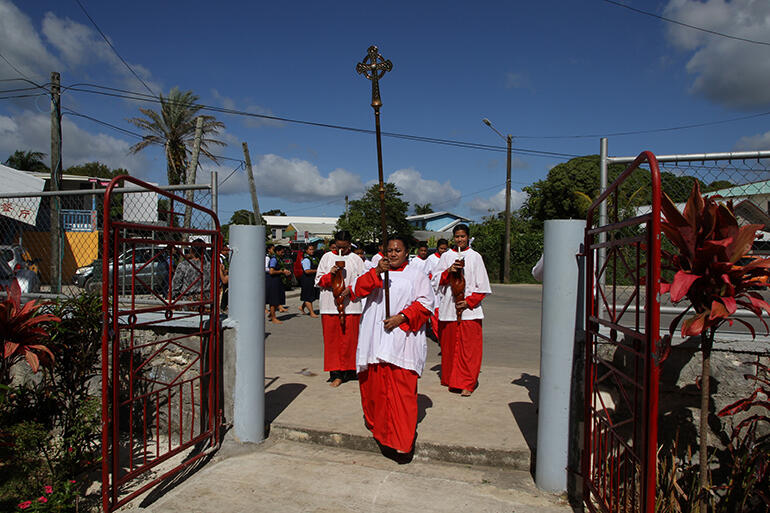The procession turns in off the road into the church. The procession turns in off the road into the church.