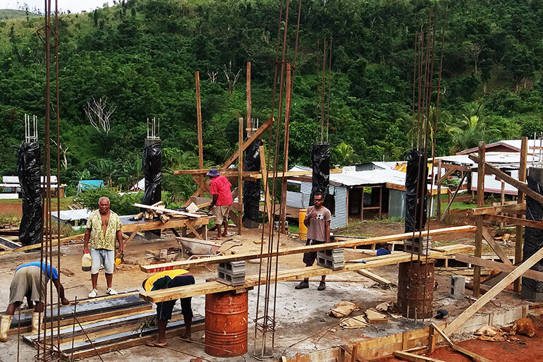 Men at work - a view across the concrete floor pad of Maniava's Church of the Resurrection.