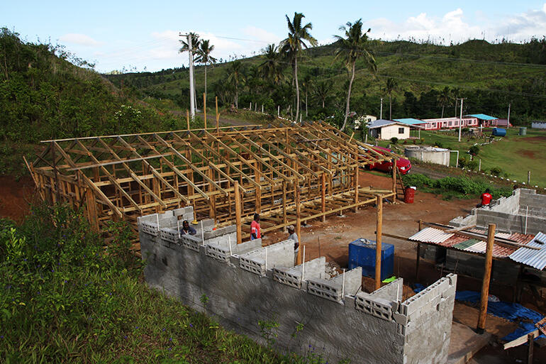 A view over the new dormitory towards Tokaimalo District School. The cyclone tore the roof off the pink classroom block. A view over the new dormitory towards Tokaimalo District School. The cyclone tore the roof off the pink classroom block.