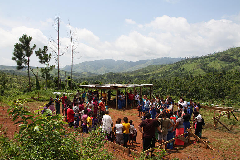 The community and the TYE visitors gather for the blessing of the church earthworks.