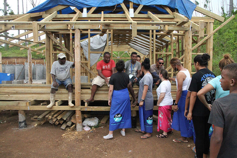 The TYE troops thank the men working on the dormitory rebuild. Alfred Williams is wearing the dark sunnies.