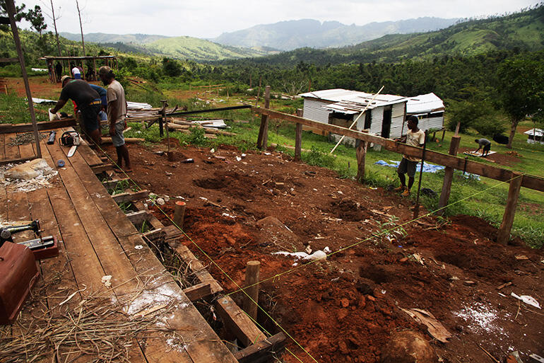 Work begins on one of the three houses to be built by Christmas. By the end of the day, piles were set in concrete.