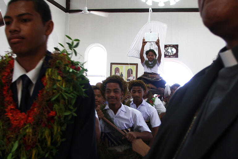 Gospel held high, the sailors - all boys from St Andrew's College - process into the church. That's Kolini Hiko in the front.