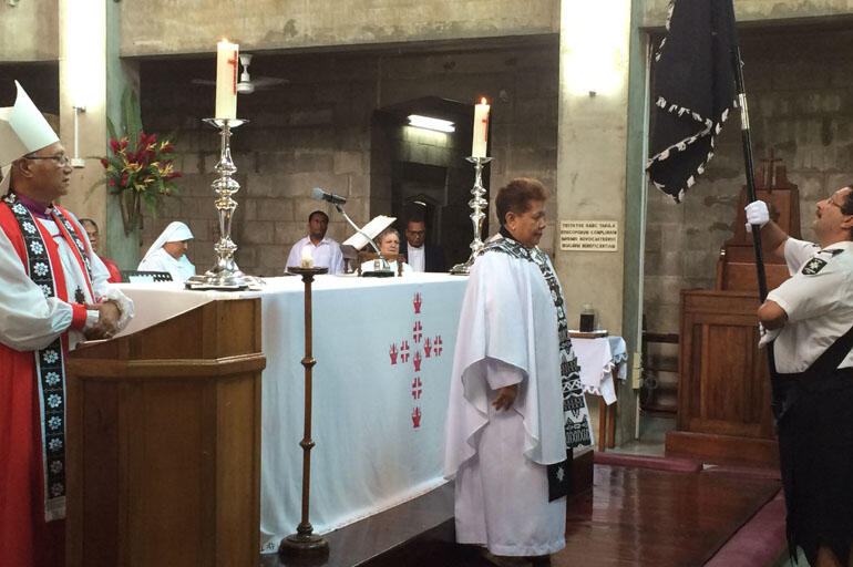 The colours of St John are presented at the altar of Holy Trinity Cathedral.