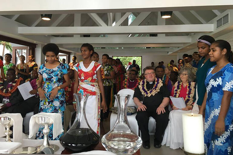 Young people of the Diocese of Polynesia encircle delegates as they lead worship during the consultation's opening Eucharist.