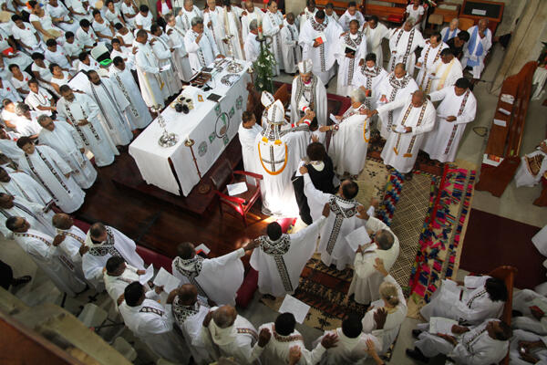 The priests of the diocese form an unbroken chain around a newly consecrated priest. The priests of the diocese form an unbroken chain around a newly consecrated priest.