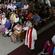 Archdeacon Richard Schwalger of Samoa holds the episcopal ring high as he moves towards Bishop Winston.