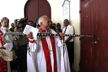 Bishop Winston strikes the Great West Doors three times with the Diocesan Pastoral Staff.