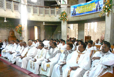 Clergy from the Suva Ovalau archdeaconry during the 'No to violence' service. Note the banner suspended from the mezzanine floor.